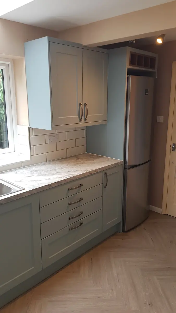 Kitchen cabinetry and herringbone-style floor