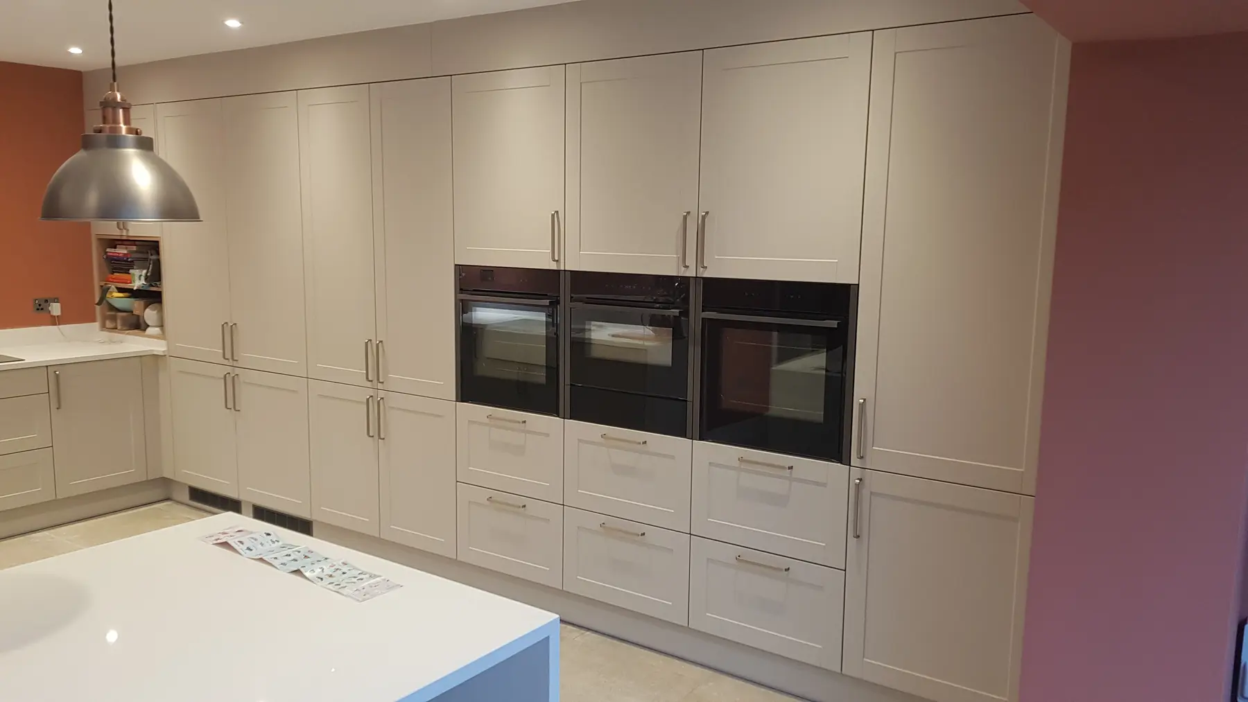 Full-height cabinetry and appliance wall