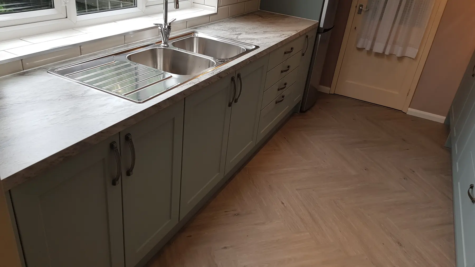 Worktop, cabinetry and finished floor